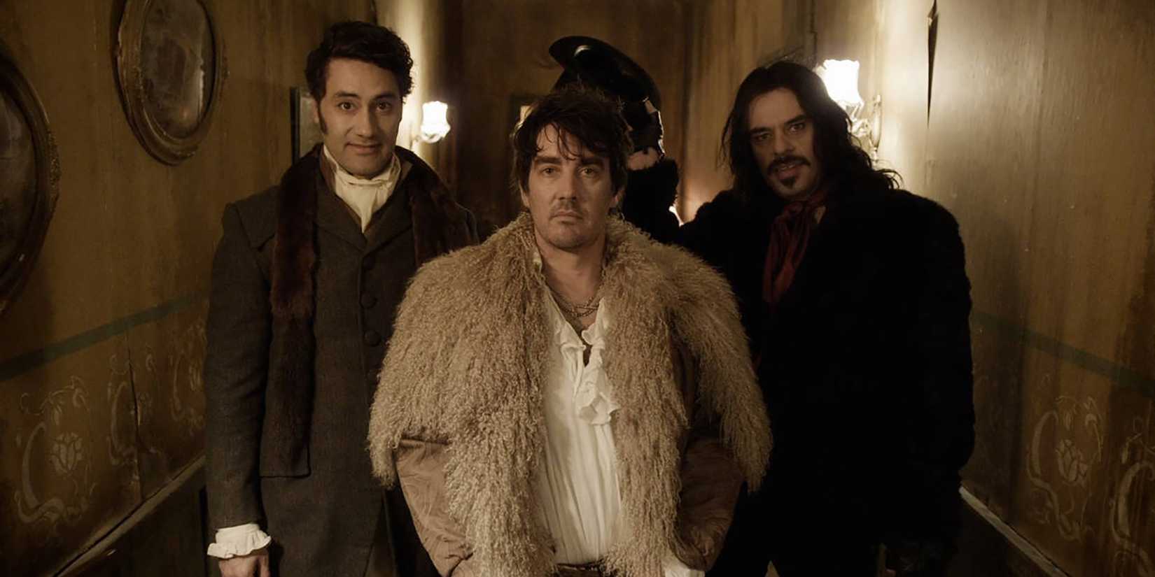 An image shows the cast of the film What We Do In The Shadows