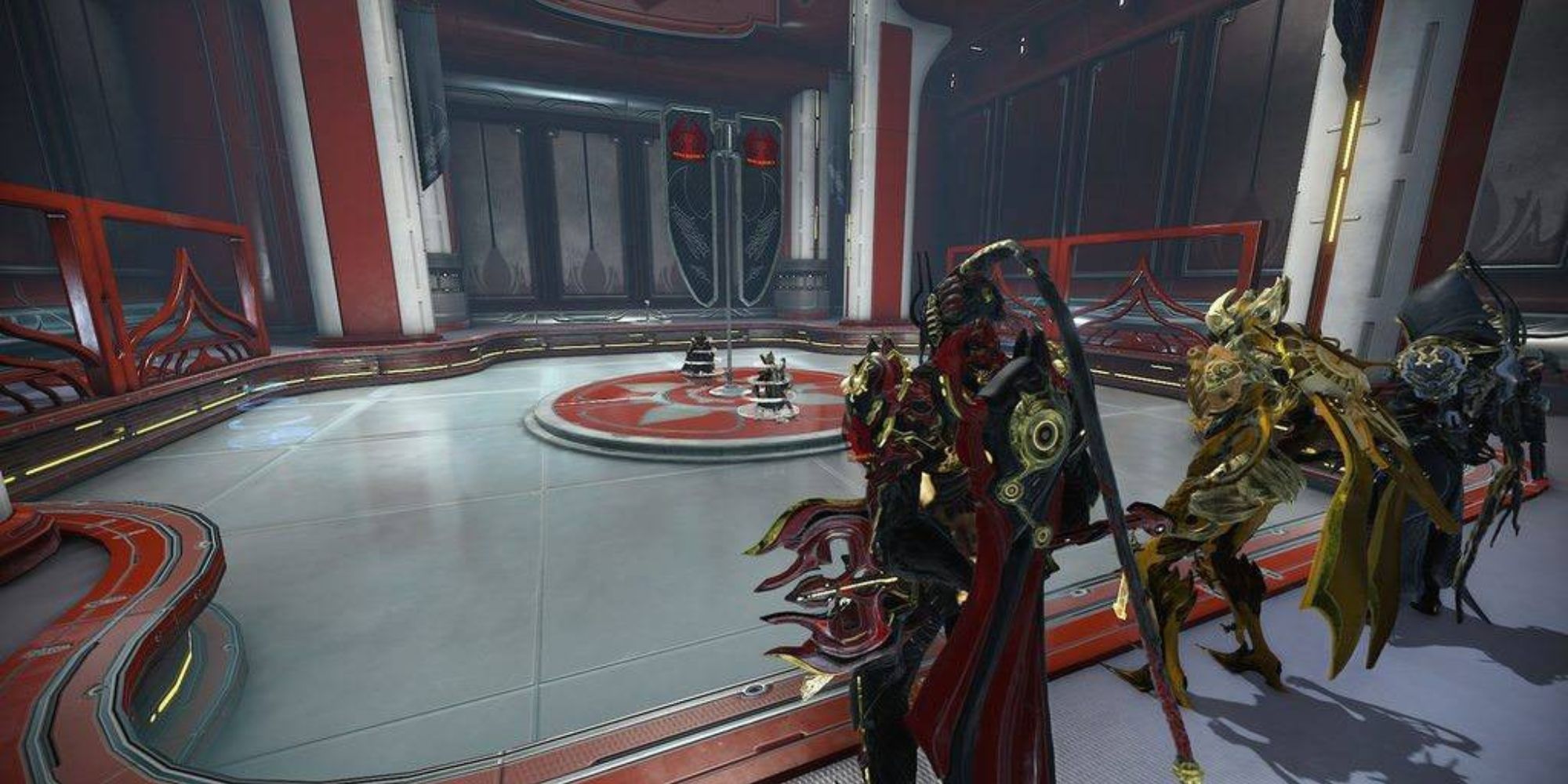 Three players standing in a guild Dojo in Warframe
