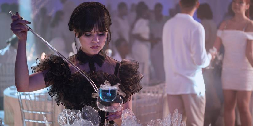 Wednesday pouring herself a glass of punch at the Rave'n Dance