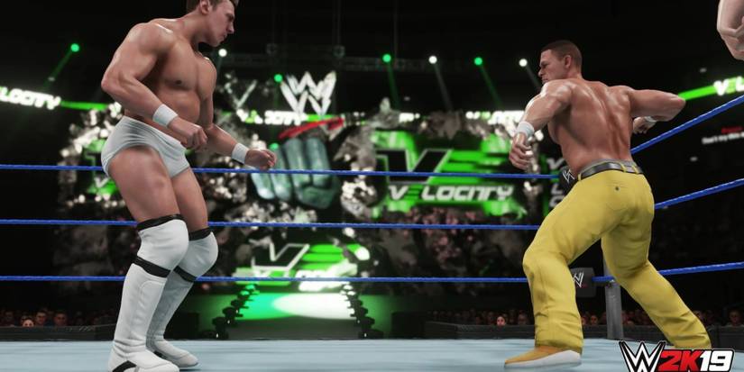 Two pro wrestlers facing off against eahc other in the ring