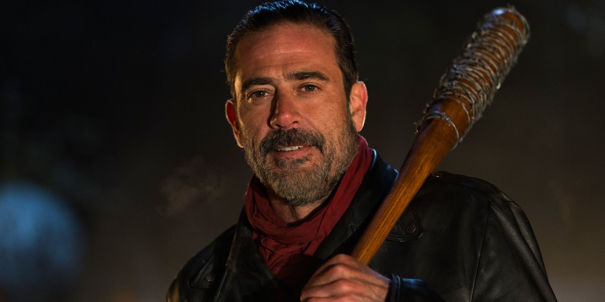 Negan smiling with a baseball bat in The Walking Dead