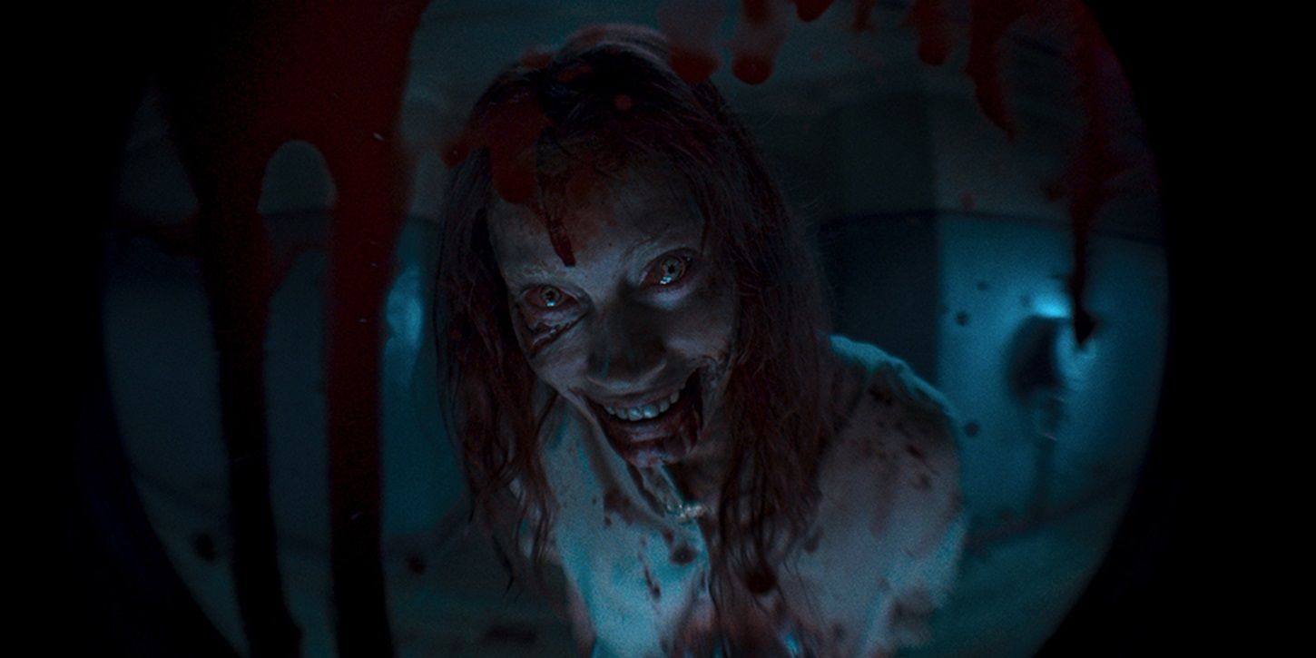 A_possessed_woman_smiling_in_the_Evil_Dead_Rise_trailer