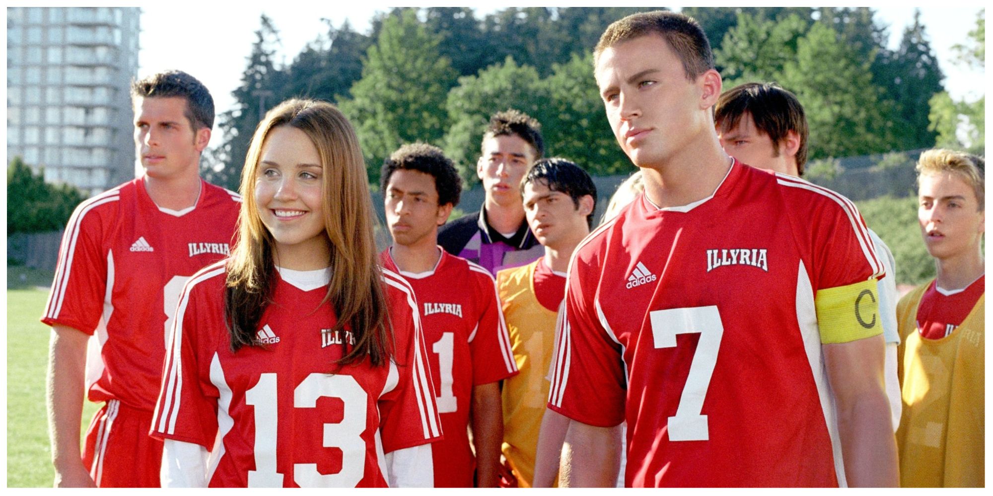 Viola and Duke standing on the football pitch with supporting cast in She's The Man.
