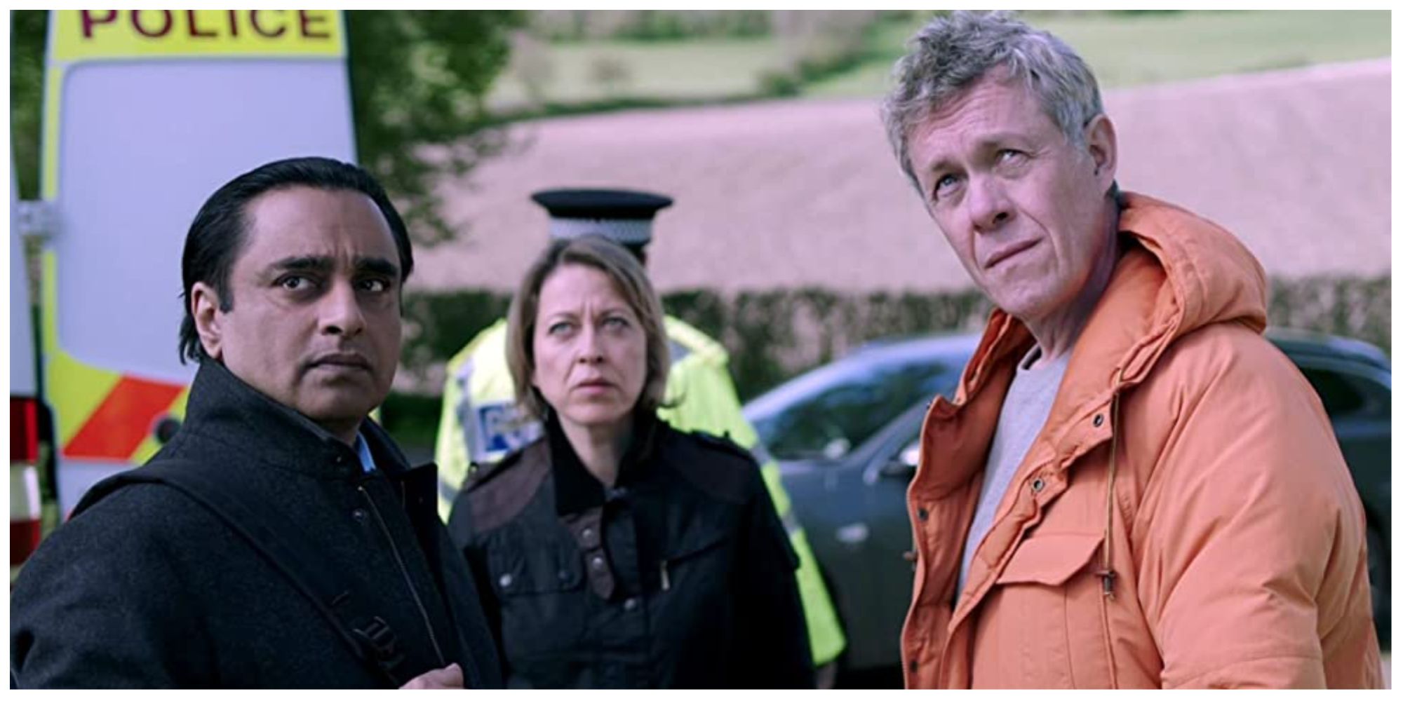 Police Detectives in Unforgotten looking up at something offscreen with grave expressions on their faces
