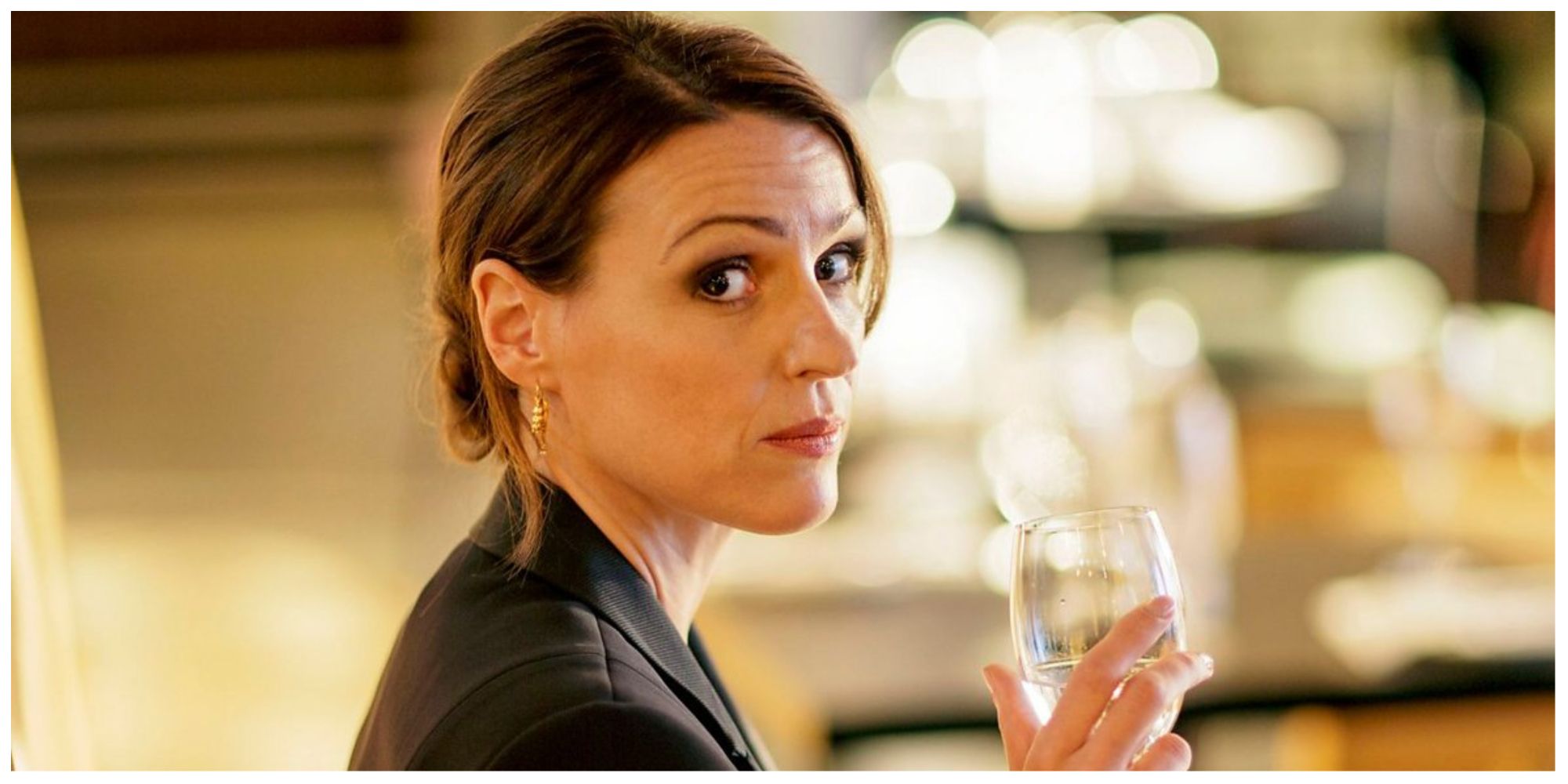 Suranne Jones as Doctor Foster looking sternly towards the camera with a drink in her hand