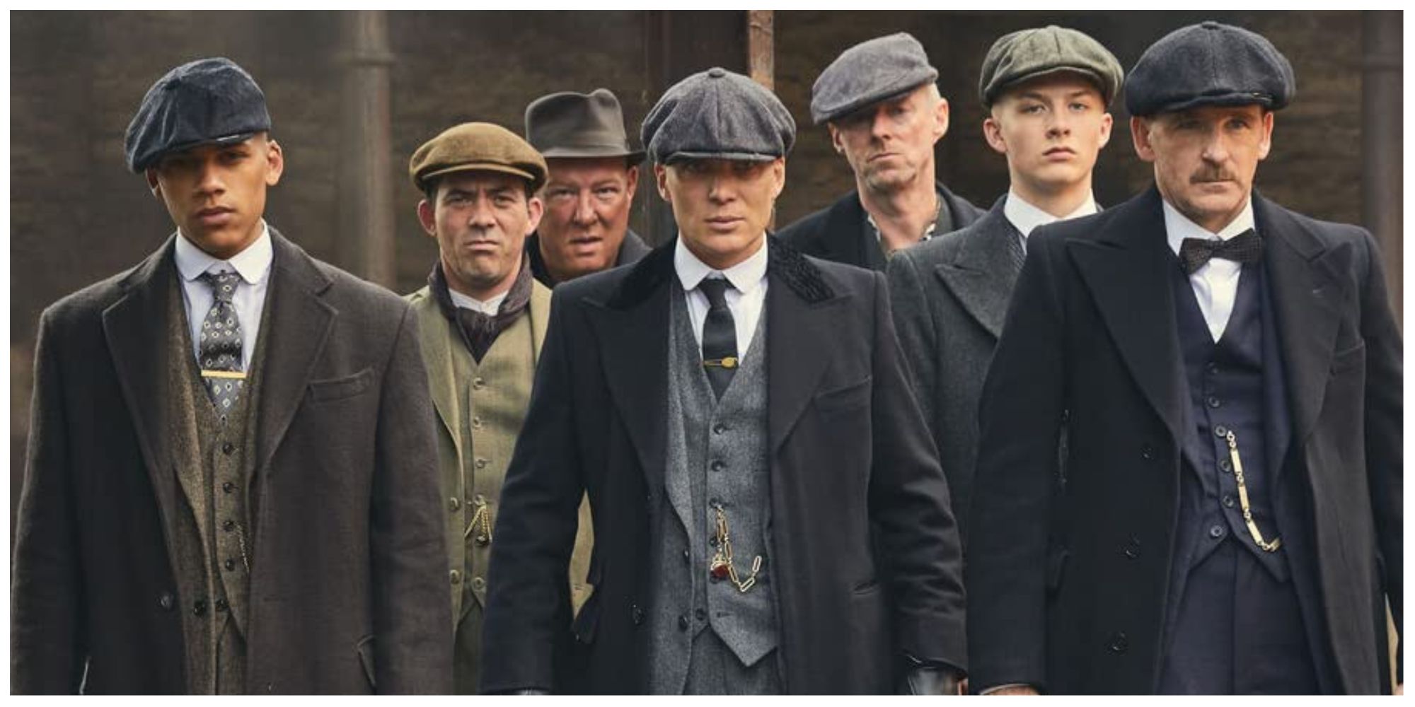 Some of the male characters from Peaky Blinders stood on the street as if braced for a fight