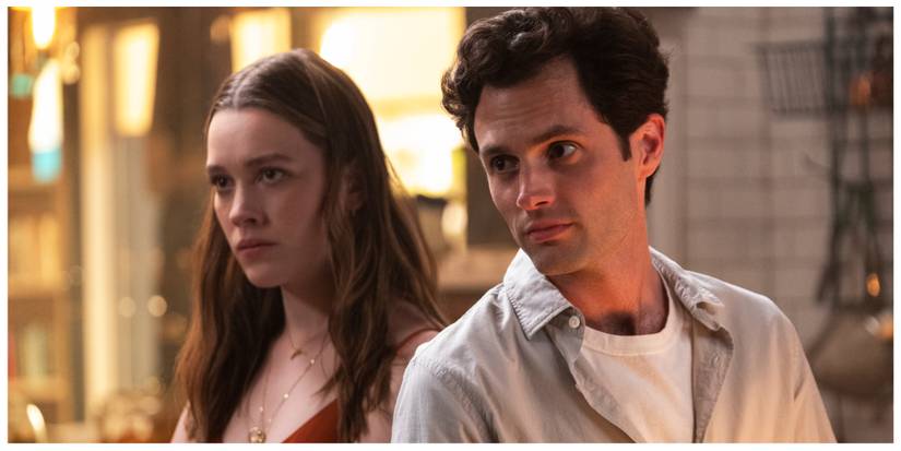 Joe and Love from You stood next to each other staring at someone offscreen