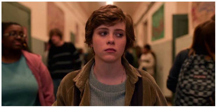 Main character Sydney walking down the school corridors looking fed up