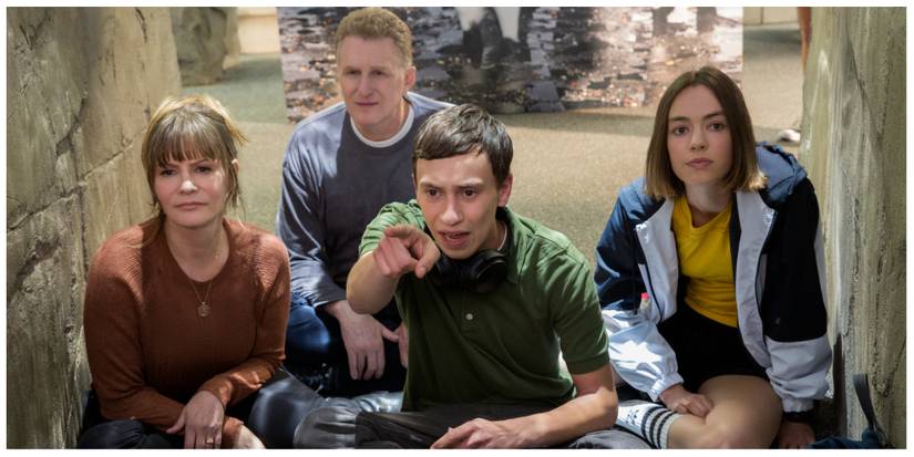 From left to right: Elsa, Doug, Sam and Casey sit looking at animals in the local aquarium in Atypical