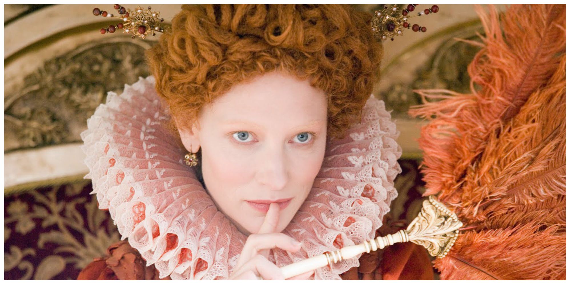 Cate Blanchett as Queen Elizabeth I in Elizabeth (1998) with her finger over her lips looking at something inquisitively offscreen