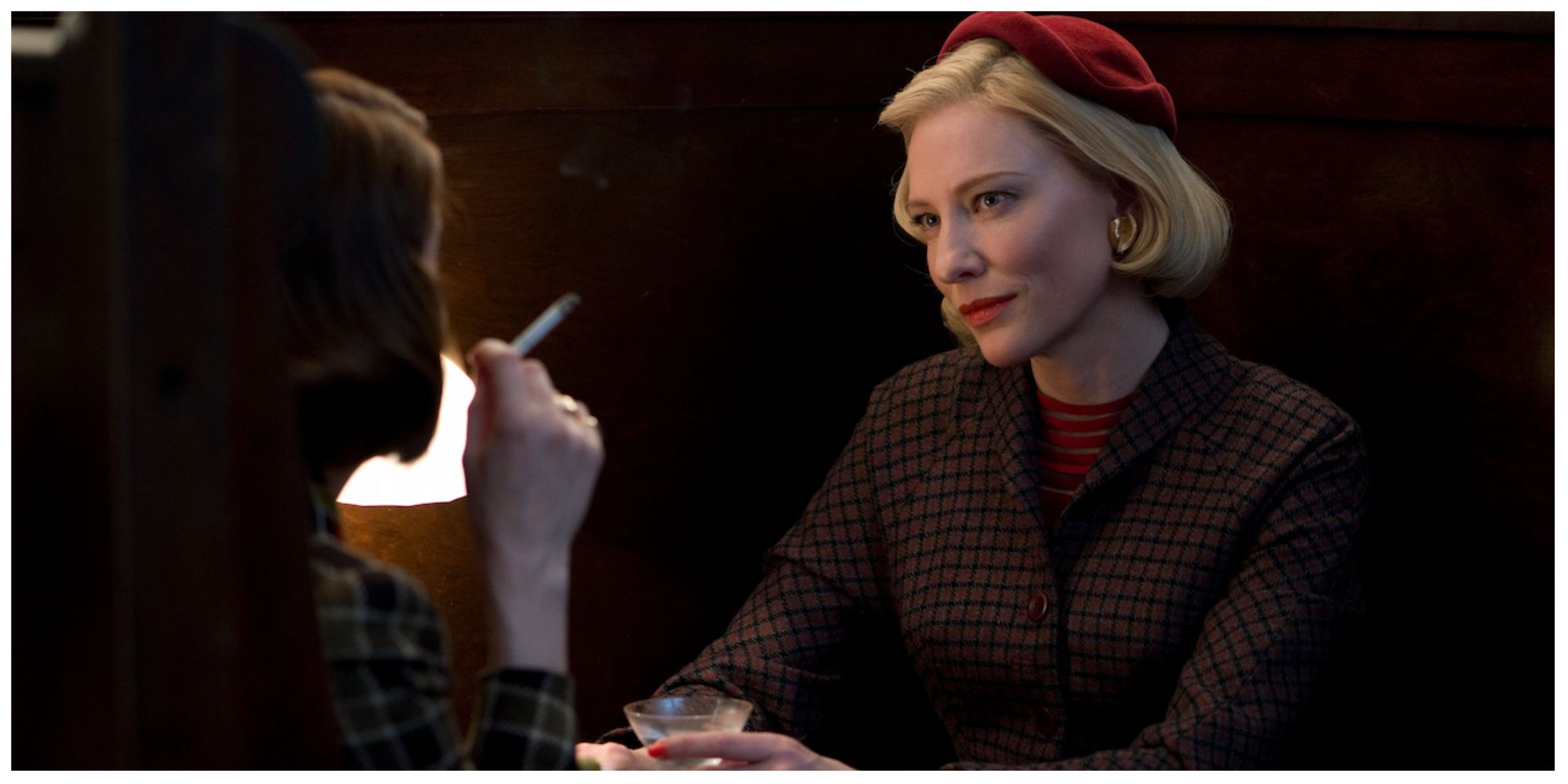 Blanchett as Carol looking and smiling at her friend at lunch.
