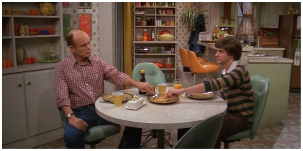 Kurtwood Smith as Red Forman. Topher Grace as Eric Forman.