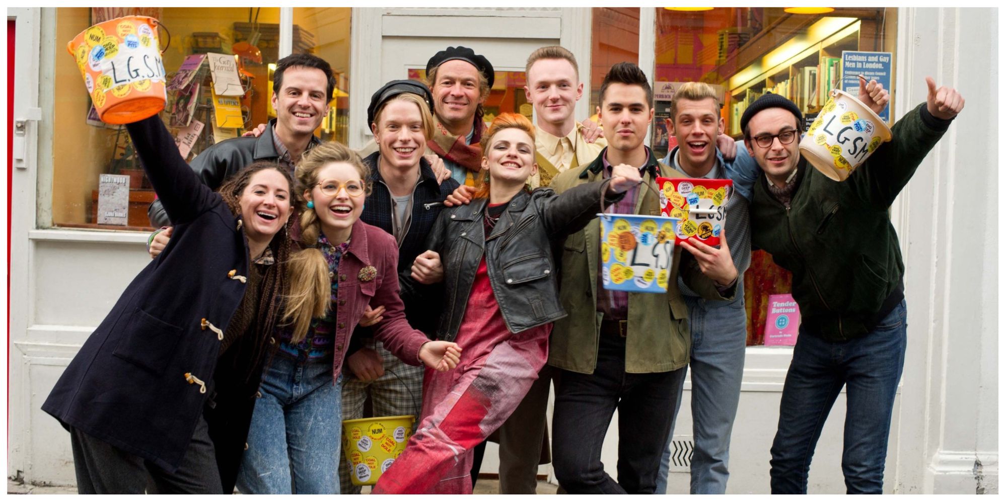 The main cast of Pride, the LGSM group, posing for a photo within the film