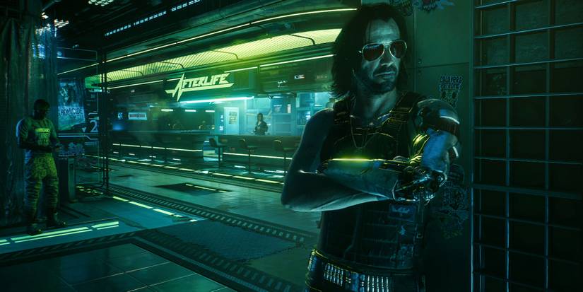 Sccreenshot from Cyberpunk 2077 showing Johnny Silverhand leaning against a wall in the Afterlife nightclub.