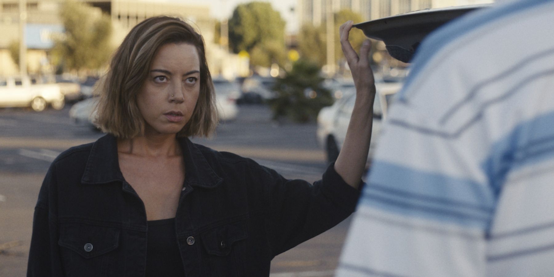 Aubrey Plaza as Emily talking to someone in Emily The Criminal