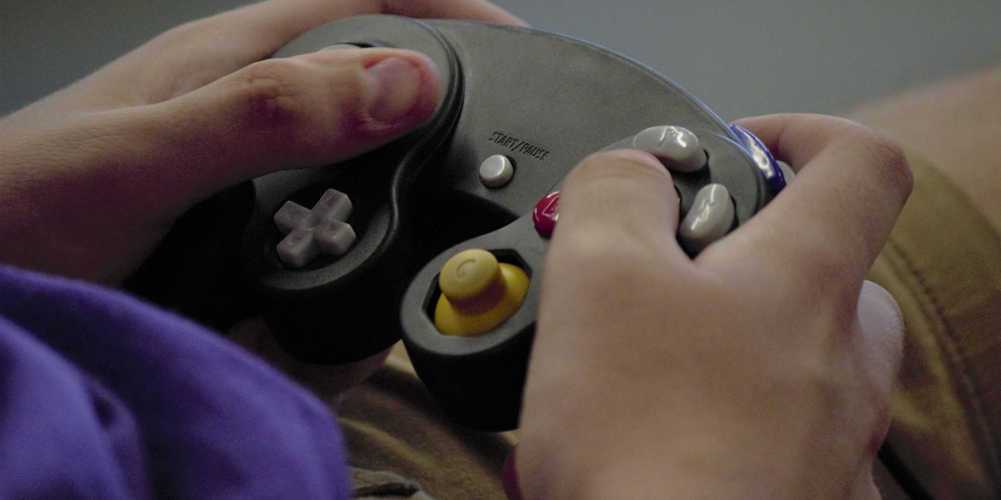 A player holding the GameCube controller