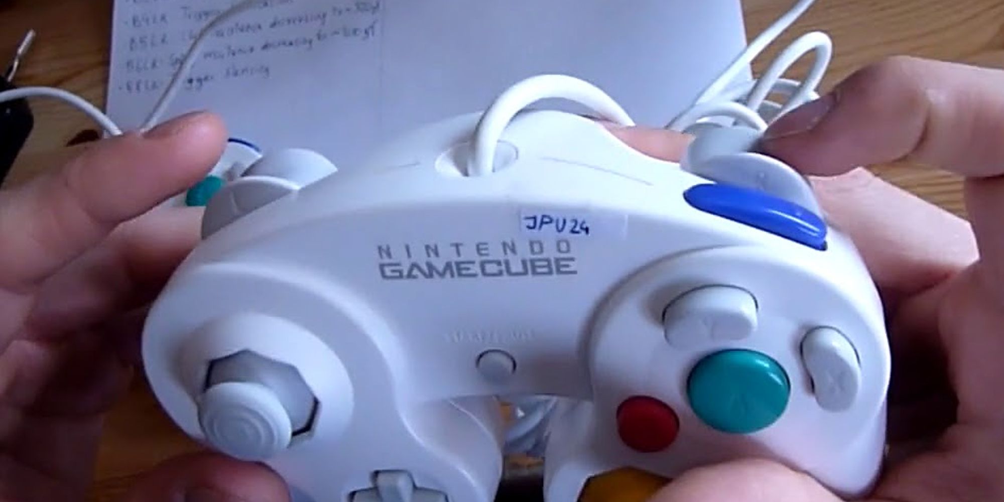 A player showcasing the top of a customized GameCube controller