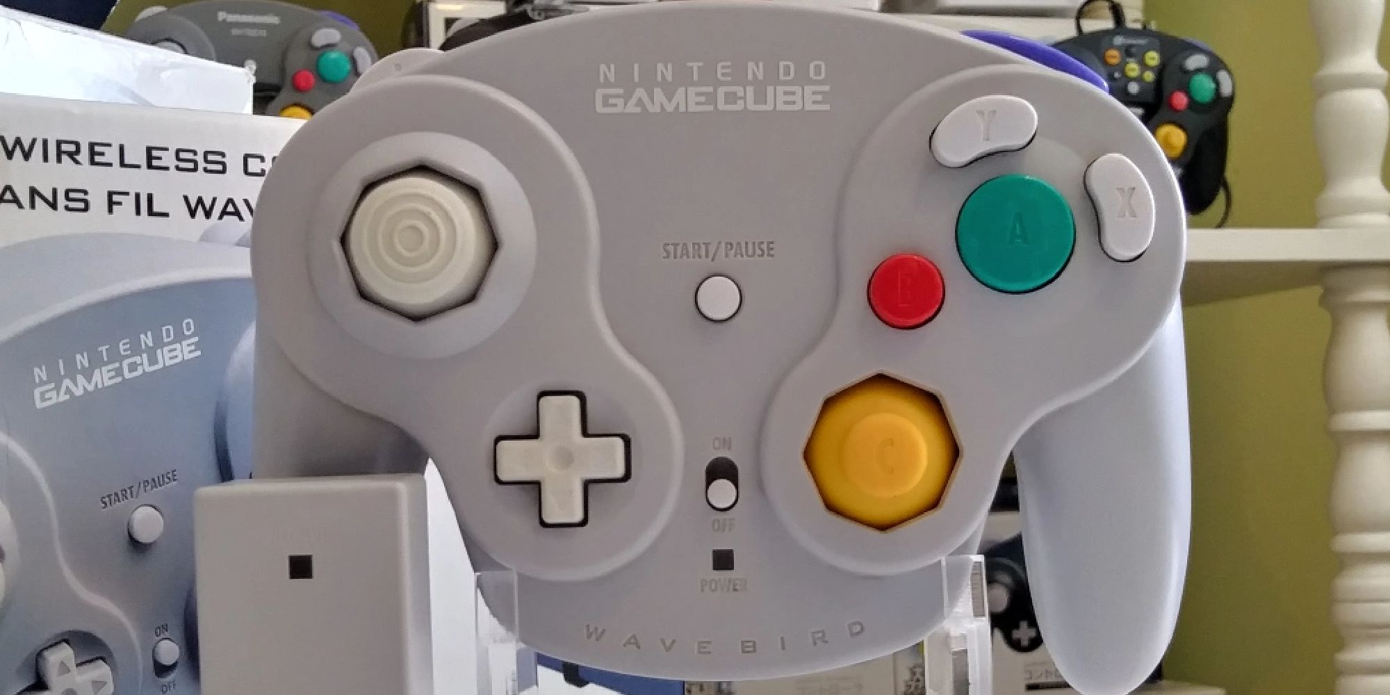 The Wavebird GameCube controller on a plastic stand