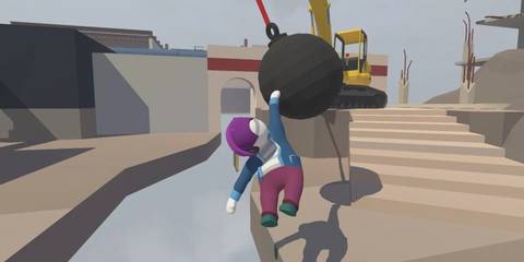 A character hanfing from a wrecking ball in Human Fall Flat