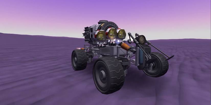 A group of Kerbal astronauts driving a rover in Kerbal Space Program