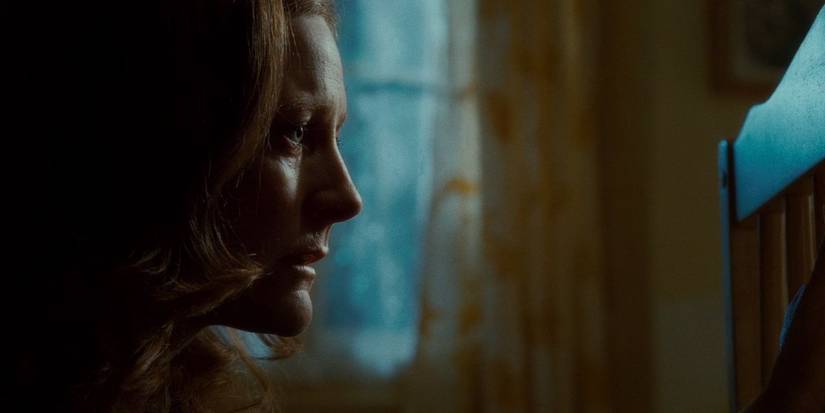 Lily Potter from Harry Potter franchise near Harry's crib