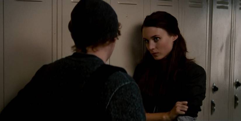 Rooney Mara as Nancy standing against lockers in A Nightmare On Elm Street (2010)