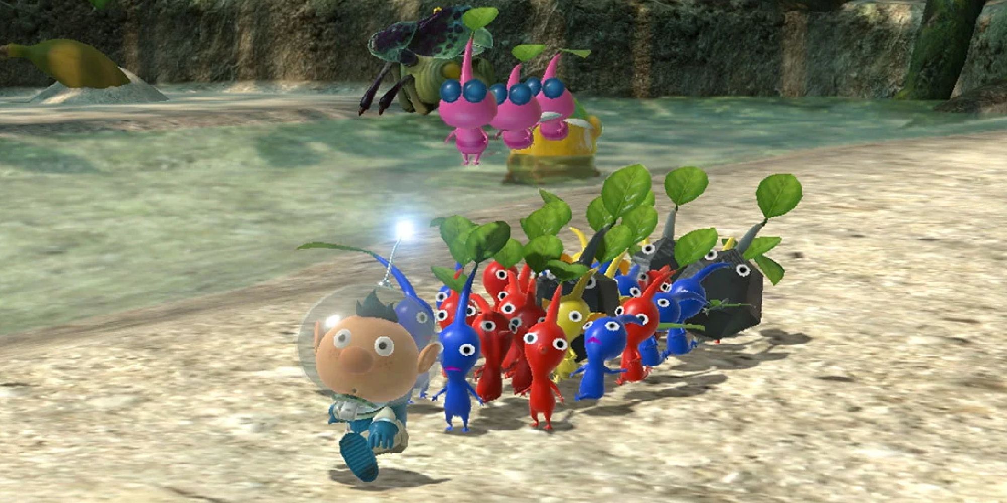 Alf walks along a lake with his Pikmin army in Pikmin 3