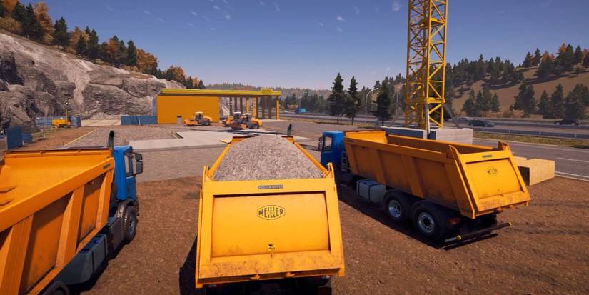 Rear View Of 3 Dump Trucks On Construction Site