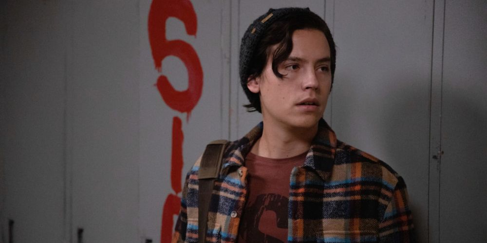 Riverdale Jughead stands in front of graffiti'd lockers