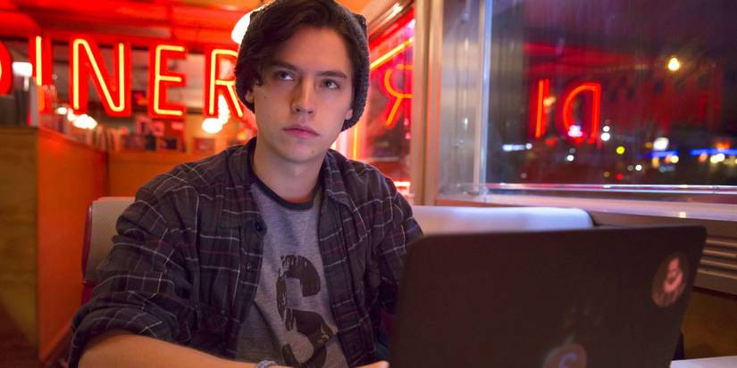 Riverdale Jughead writes on his laptop in Pop's Chock'lit Shoppe