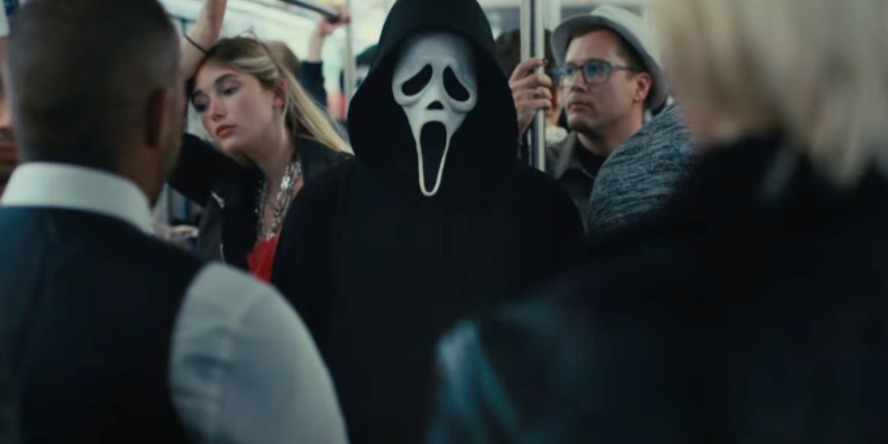 Ghostface standing on the subway in Scream 6