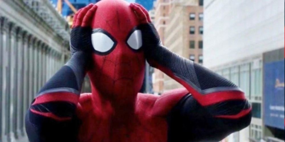 Tom Holland as Spider-Man, holding his head with a shocked expression.