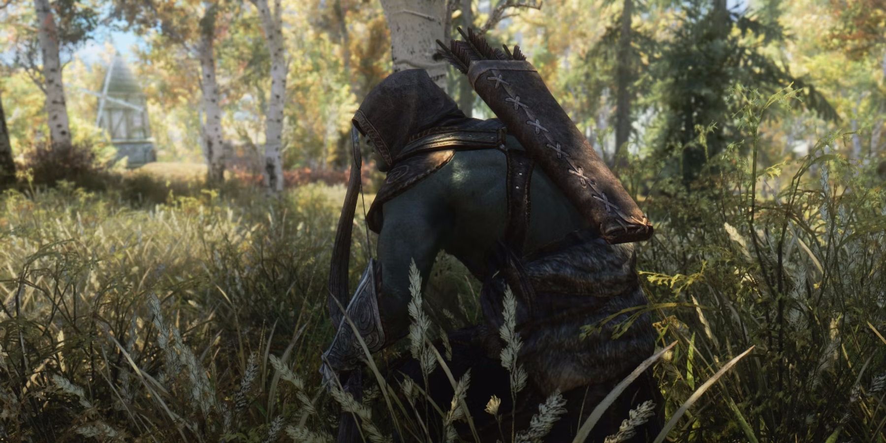 Screenshot of a Skyrim archer crouching in tall grass