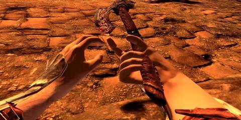 Screenshot from Skyrim VR showing the player lying on the ground while holding an axe.