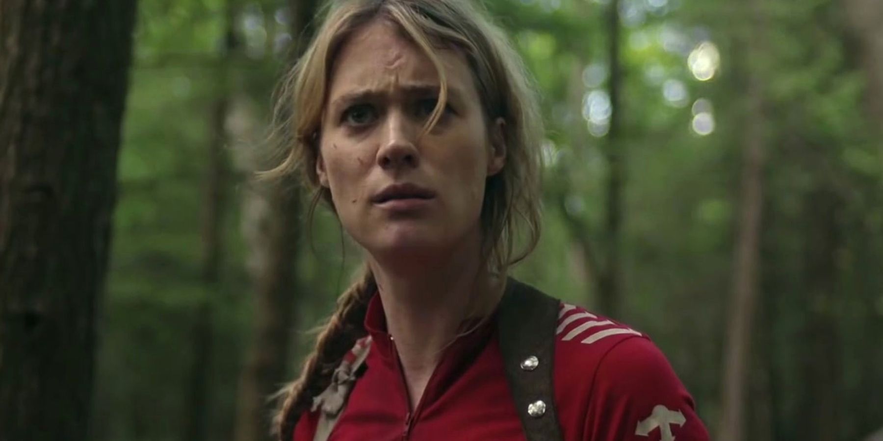 Mackenzie Davis as Kirsten looking upset in the forest in Station Eleven