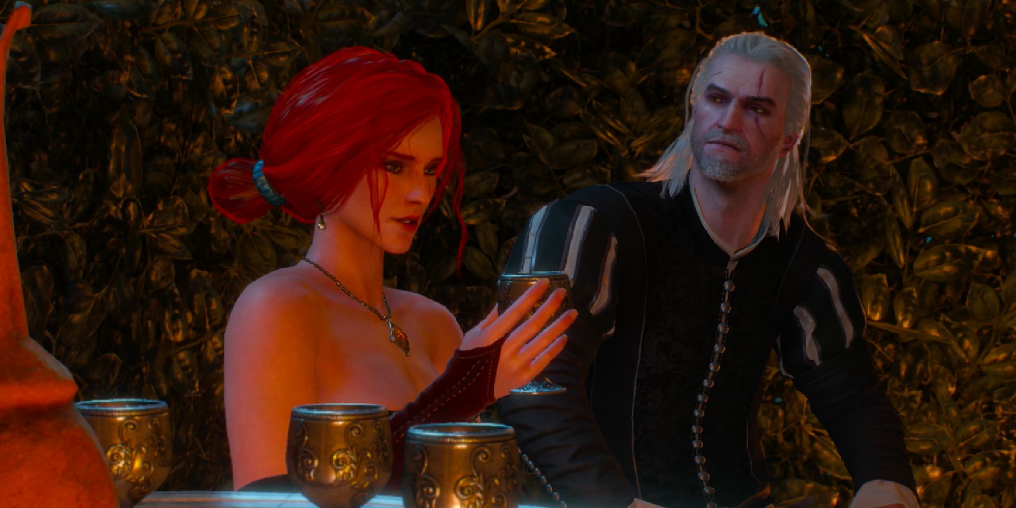 Triss and Geralt sitting at a table surrounded by wine cups.