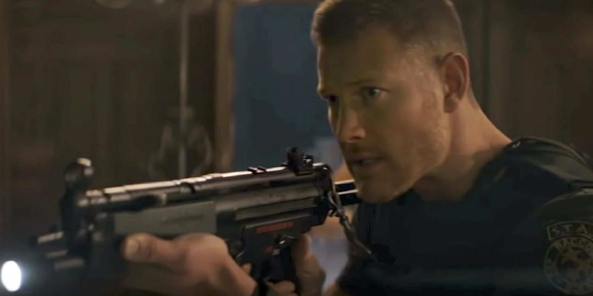 Wesker as seen in the movie, levelling a rifle at an unseen opponent.