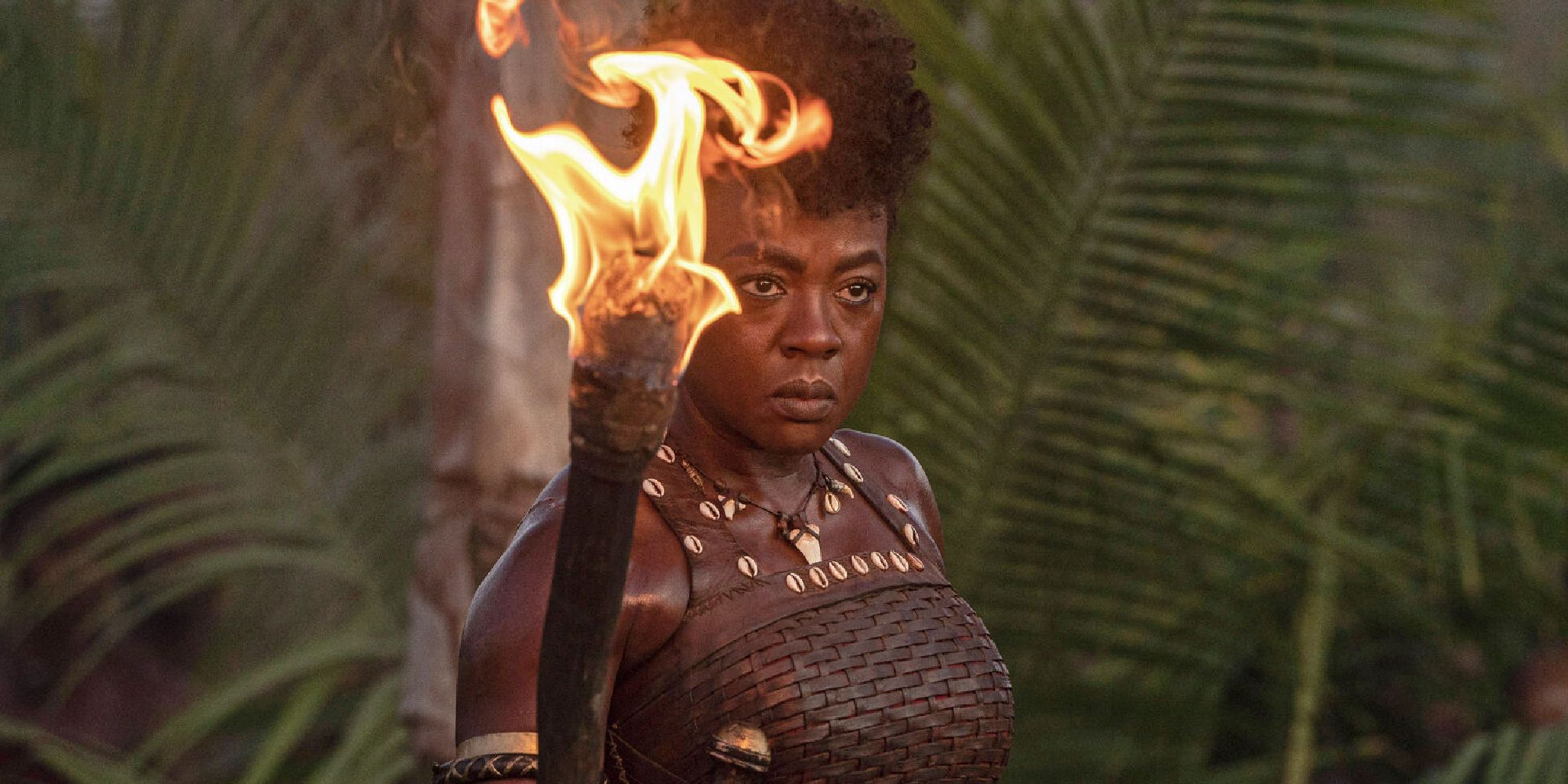 Viola Davis holding a torch in The Woman King