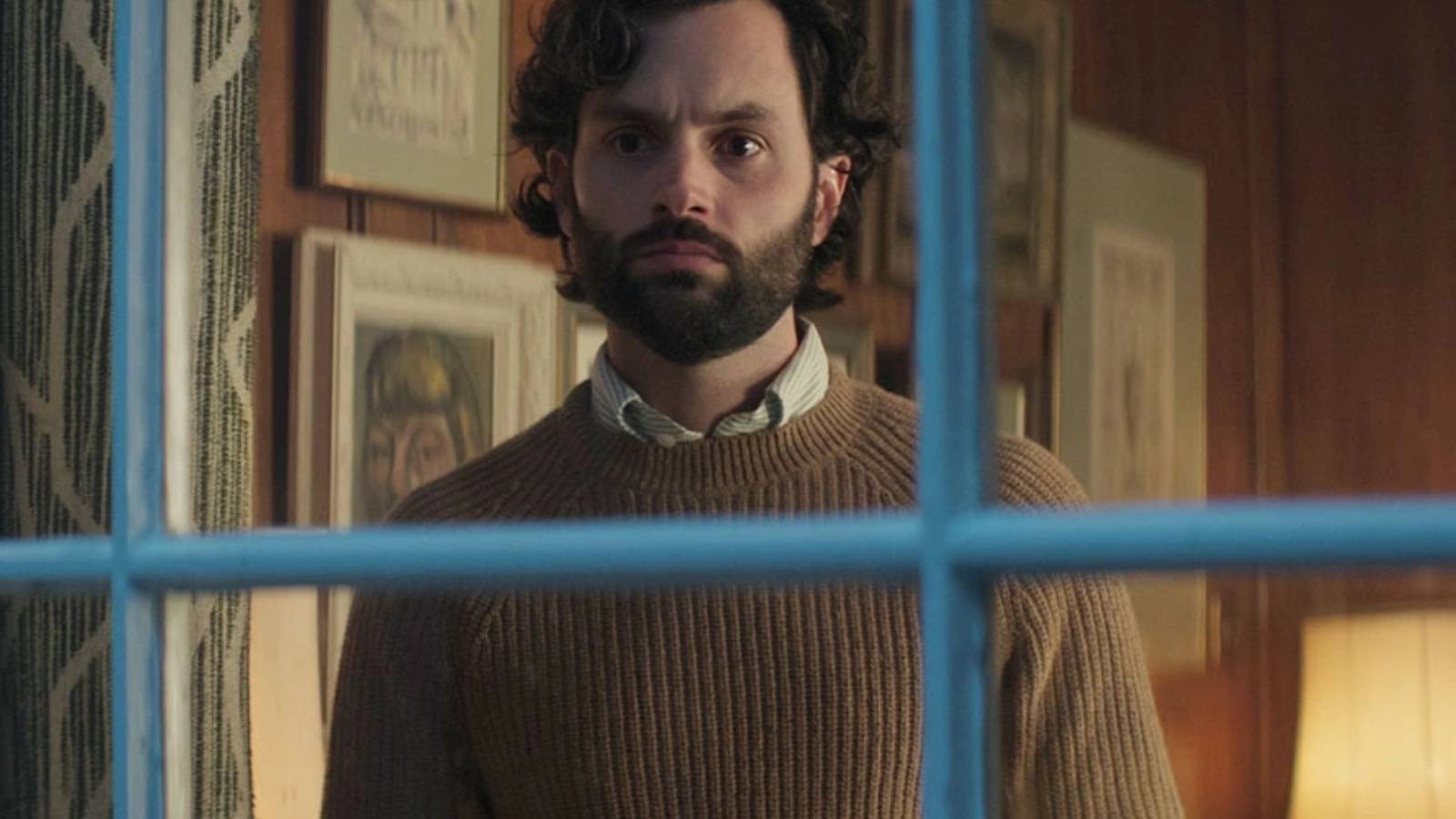 Penn Badgley as Joe Goldberg staring out the window in season 4 of You