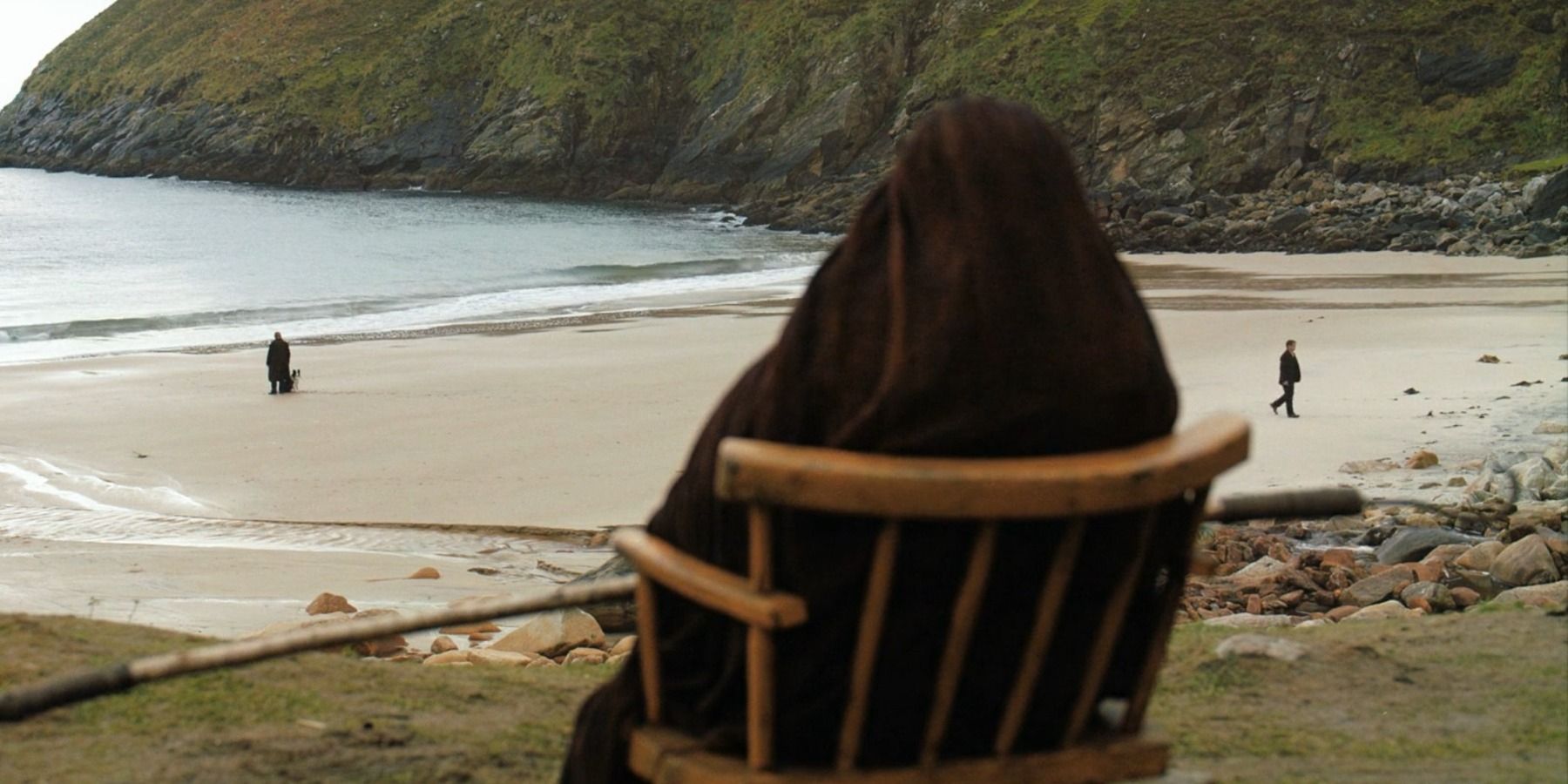 Mrs. McCormick staring at the beach from cliff in The Banshees of Inisherin ending