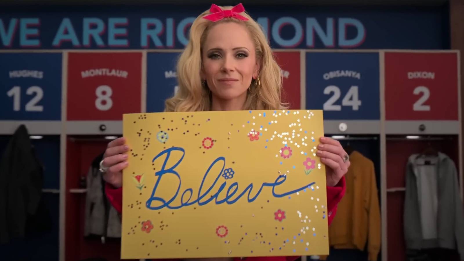 Ted Lasso season 3 teaser Juno Temple as Keeley Jones holding Believe sign