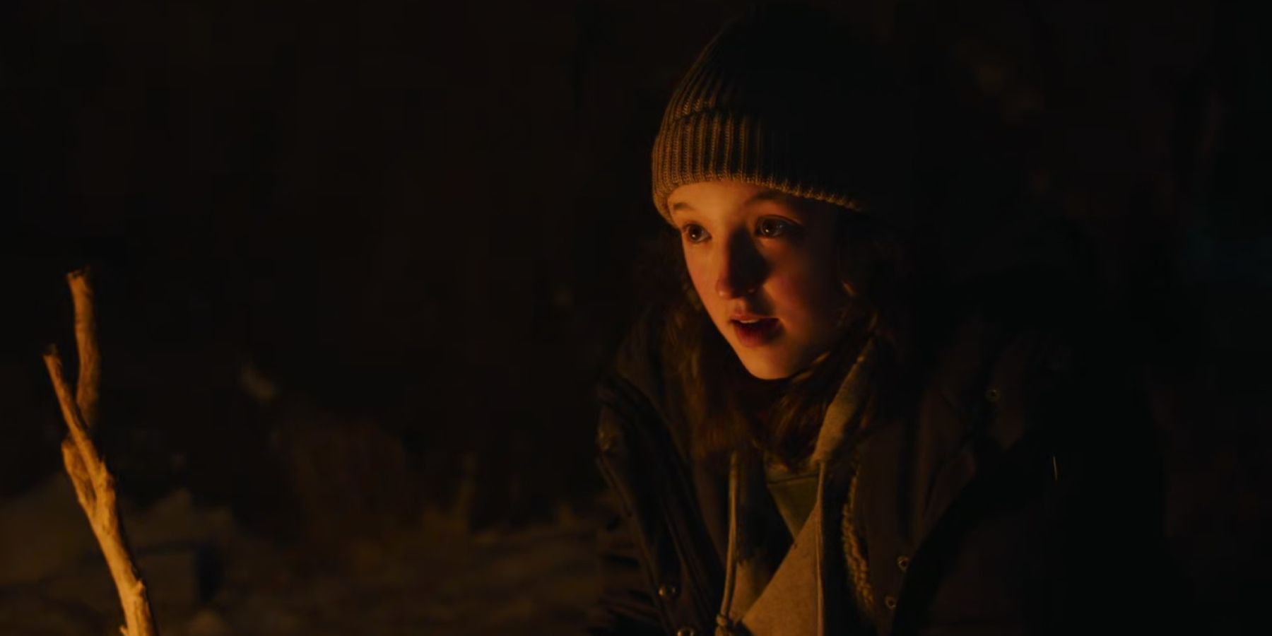 Bella Ramsey as Ellie by campfire in HBO's The Last of Us