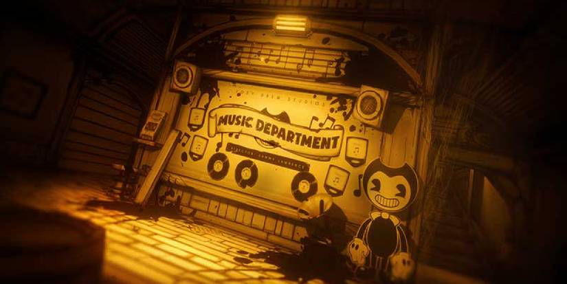 A cardboard cutout of Bendy standing next to a sign. 