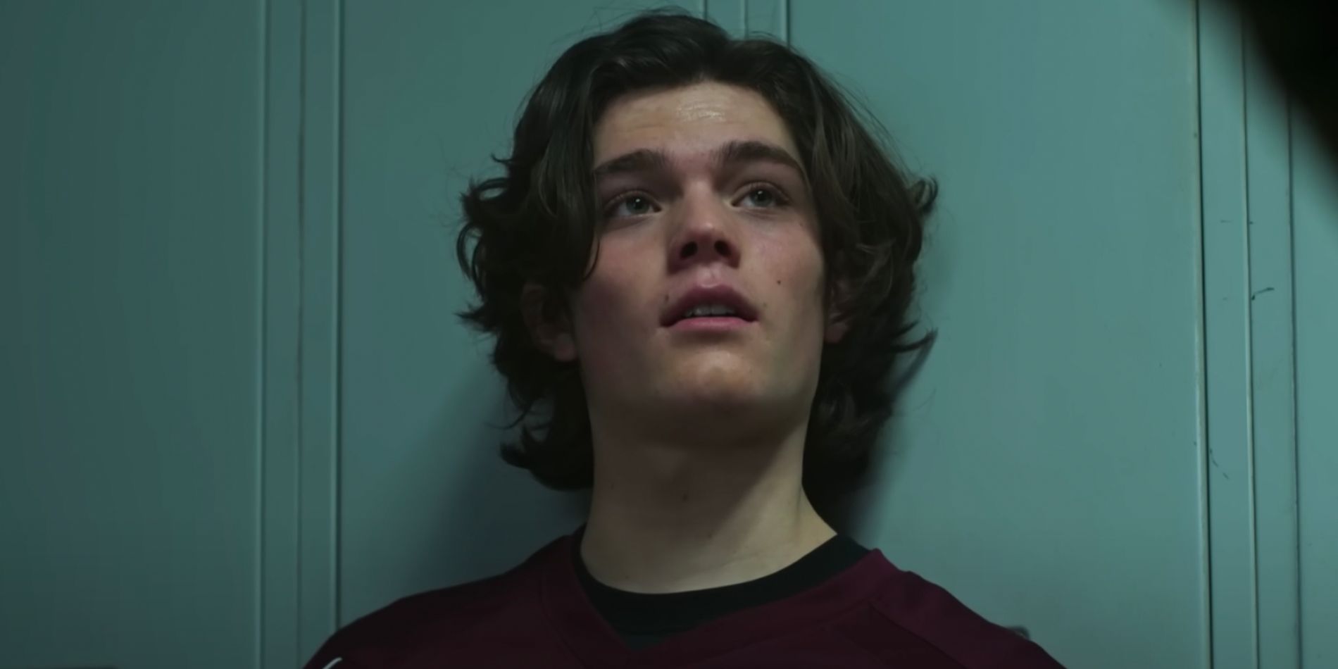 Eli Hale leans against lockers in the Teen Wolf movie