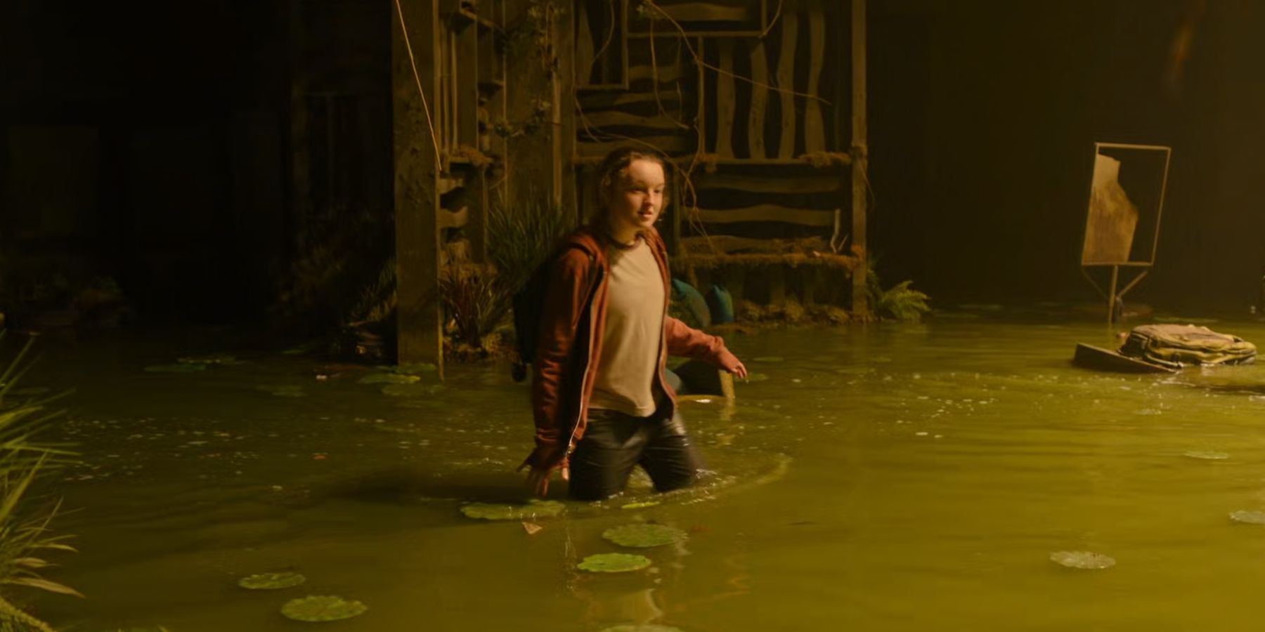 Ellie trudging through water in The Last of Us.