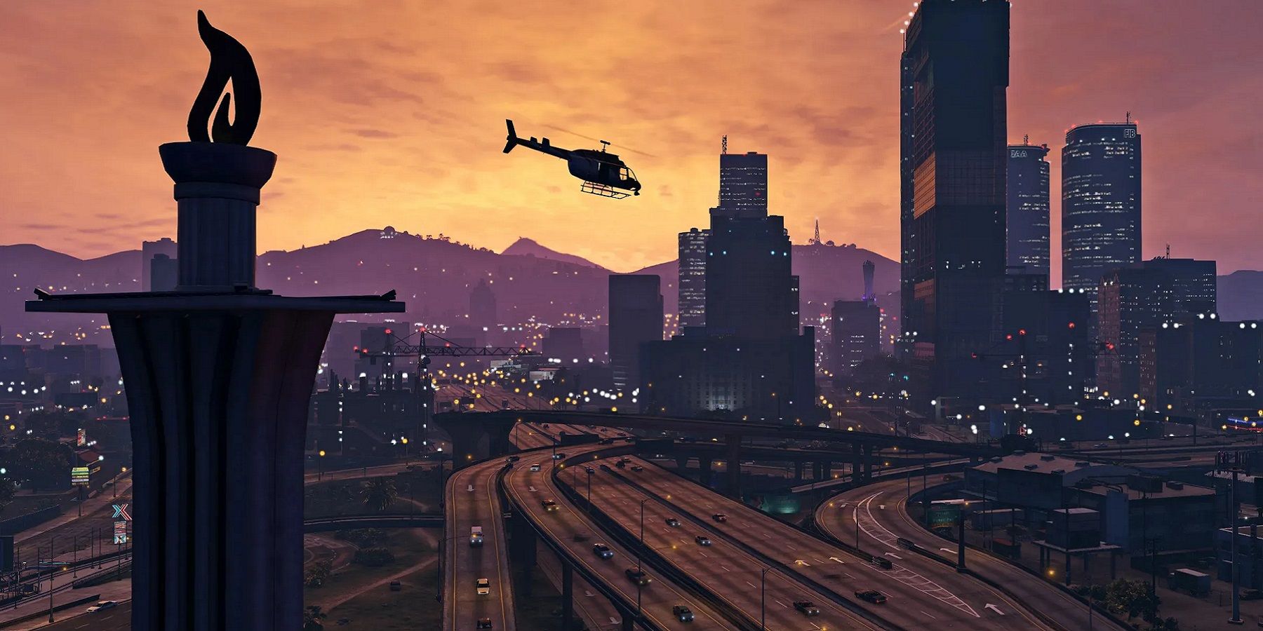 Hình ảnh góc rộng từ Grand Theft Auto 5 cho thấy một chiếc trực thăng bay qua thành phố trong hoàng hôn..