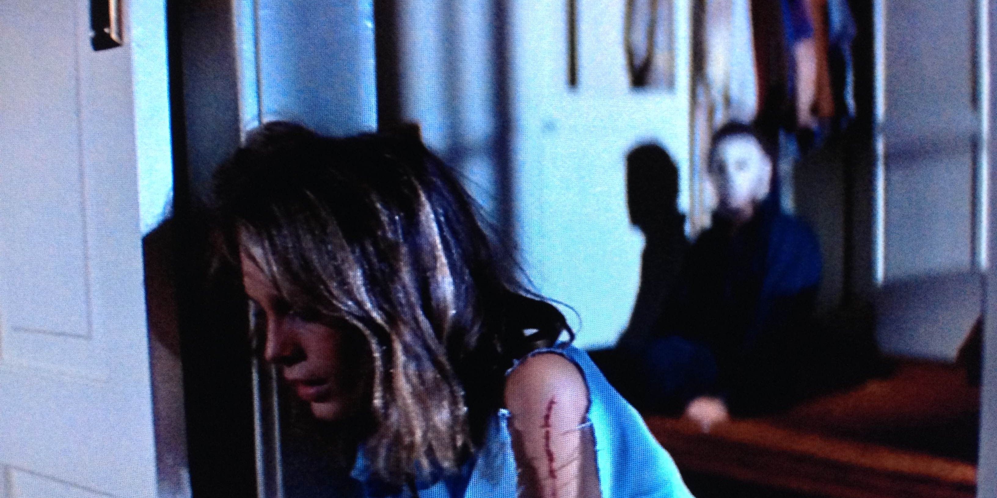 Laurie (Jamie Lee Curtis) unaware of Michael Myers behind her in Halloween (1978).
