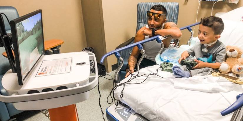 Hospital patient playing on video games with Gamers Outreach GO-Kart