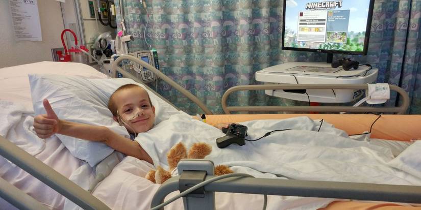 Hospital patient with Gamers Outreach GO-Kart playing Minecraft