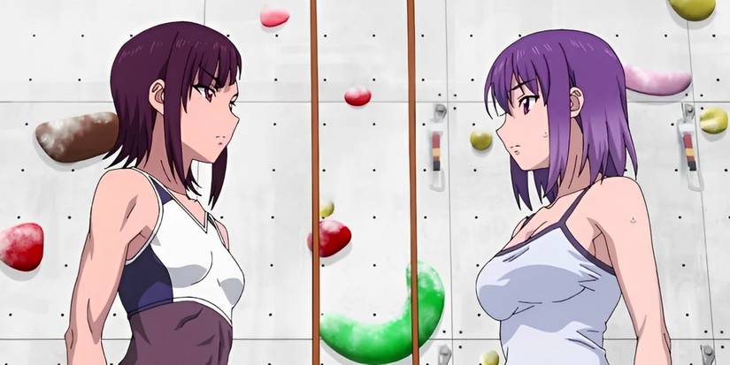 Two girls standing in front of a climbing wall